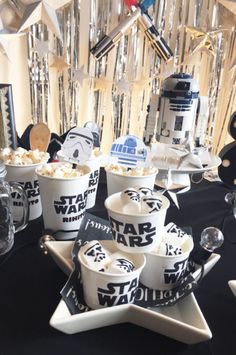 star wars themed desserts are displayed on a table with other decorations and decor items