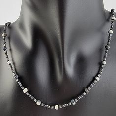 Handmade unisex beaded necklace with seed beads in black and white, grey, and black Cheap Festival Necklaces With Black Beads, Cheap White Necklace With Black Beads, Silver Beaded Necklace With Black Hematite Beads, Silver Hematite Beaded Necklace With Black Beads, Black Hematite Beaded Necklaces With Round Beads, Black Hematite Beaded Necklaces, Adjustable Gray Necklace With Silver Beads, Necklace With Beads, Handmade Beaded Necklace