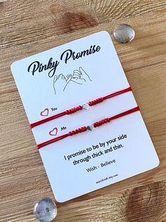 two red string bracelets with one saying only promise and the other saying i promise to by your side through tick and dan