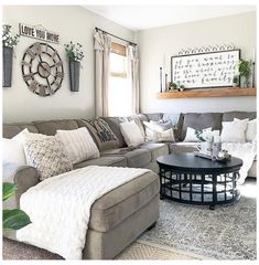 a living room filled with lots of furniture and pillows on top of a carpeted floor