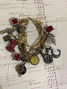 a bunch of charms that are on top of a piece of paper with writing in the background