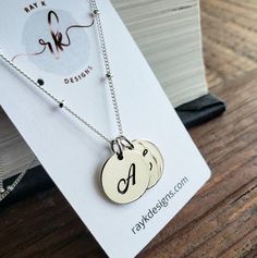 a timeless sterling silver script letters charms hang from elegant sterling silver satellite chain. all findings are sterling silver. 16'' with 2'' extender.sterling silver disc-13mm*only available in sterling silver***Please indicate the following information in the "message to seller" box at the checkout..1. 2 initials of your choicehere's more personalized options for your bridal party.http://www.etsy.com/shop/thejewelrybar?section_id=7033278 Custom Name Sterling Silver Jewelry For Best Friend, Silver Sterling Name Necklace For Anniversary, Silver Sterling Silver Name Necklace For Anniversary Gift, Silver Sterling Silver Name Necklace For Anniversary, Silver Initial Necklace In Sterling Silver, Sterling Silver White Gold Initials Name Necklace, Silver Jewelry With Initials For Anniversary Gift, Silver Jewelry With Initials For Anniversary, Monogram Sterling Silver Jewelry For Mother's Day