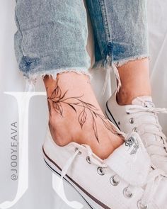 a woman's foot with a flower tattoo on it