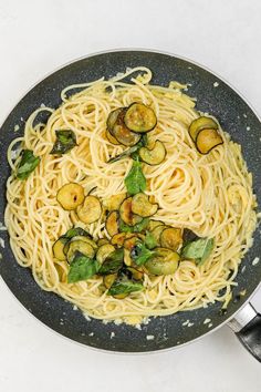 pasta with zucchini and brussel sprouts in a frying pan