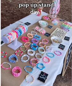 a table topped with lots of different bracelets