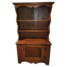 an old wooden bookcase with drawers and cupboards