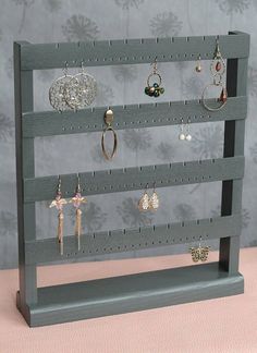 there is a display rack with earrings on it