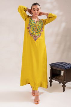 The embellished Kameez Trouser Raw Silk Pakistani Eid Dress is a perfectly stitched masterpiece adorned with glamorous details of crystals and beads. Shimmering sequins and embroidery work give a traditional touch to this premium Pakistani Dress, making it an epitome of beauty. Detailed Description: SKU: PS1826 Detailing: Embroidery, Threads, Pearls, Sequins, Beads Color: Yellow Fabric: Raw Silk, Organza Design: Fully Embroidered dress Event: Festive, Party wear Momal Sheikh, Eid Dress, Dress Event, Eid Dresses, Embroidery Threads, Pakistani Dress, Silk Organza, Yellow Fabric, Embroidery Work