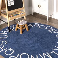 a child's room with a blue rug that says, i love my children