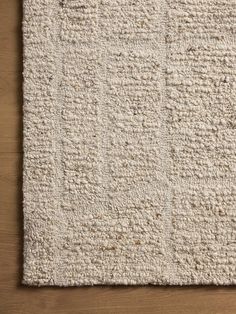 a white rug on top of a wooden floor