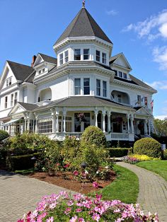 a large white victorian style house with a turret