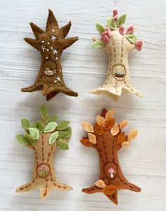 four different types of felt trees on a table