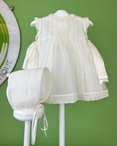 Smock Dress - Baptism Dress for Baby Girl - Made in Spain. Christening dress with smock detail. Off-white, lace, traditional, baptism dress. YoYo Boutique is located in Miami, and specializes on christening dresses, and baptism dresses. We ship worldwide. Cream A-line Daywear Dress, White A-line Dresses With Lace Collar, White Sleeveless Dress With Smocked Back, Sleeveless Lace Dress For Ceremonies, Elegant Baptism Dress With Smocked Back, Elegant Dress With Smocked Back For Baptism, Spring Ceremony Dresses With Ruffles, Elegant Broderie Anglaise Baptism Dress For Spring, Elegant Spring Baptism Dress With Broderie Anglaise