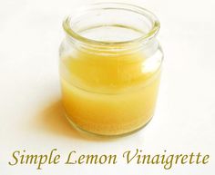 a glass jar filled with yellow liquid sitting on top of a white table next to the words simple lemon vinagrete