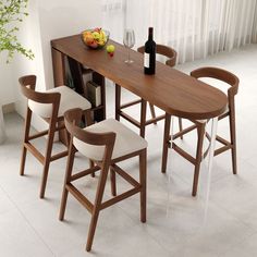 a dining table with four chairs and a wine bottle