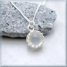 An 8mm white moonstone sits in a gallery wire bezel setting. This gemstone is a lovely accent piece for everyday wear - beautiful neutral that goes with anything. Moonstone is also one of the June birthstones. Sterling silver curb chain and setting. Jewelry is packaged in a cotton lined box for gift-giving. See more Bonny Jewelry at http://bonnyjewelry.etsy.com If this is a gift and you would like to include a short note with the item, please include this information in the Note to Bonny Jewelry Gemstone Pendant Jewelry, Talisman Necklace, Gold Bar Necklace, White Moonstone, Jewelry Sterling Silver, Silver Work, Moonstone Necklace, Necklace Gemstone, Gem Stone