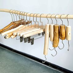 several wooden objects hanging from hooks on a wall