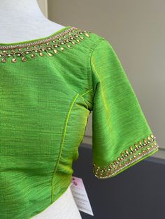 Parrot Green Color Raw Silk Readymade Blouse with beautiful Handwork Work. Item : Readymade BlouseSize : 36 (Can be opened to Size 40)Length of the Blouse : 14 inches Length of the Sleeves : 10 inches Color : Parrot Green Blouse Fabric : Soft Silk Lining : Yes, it is fully lined Padded or Non-Padded : PaddedClosure: Back Closure with hooks.Ready-to-Wear : YesDisclaimer - : -This is a Standard Size blouse. We do not guarantee perfect fit as every body and shape is different. Little or no alterati Fitted Green Blouse With Short Sleeves, Fitted Green Short Sleeve Blouse, Festive Fitted Green Blouse, Green Short Sleeve Blouse For Festive Occasions, Green Short Sleeve Festive Blouse, Festive Green Short Sleeve Blouse, Fitted Green Festive Top, Fitted Green Top For Festive Occasions, Summer Fitted Cutdana Blouse