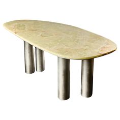 an oval marble table with metal legs on a white background for use as a coffee table