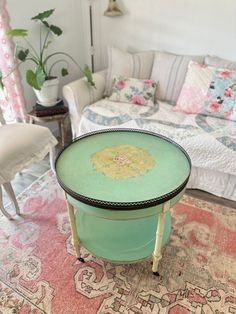 a green table sitting on top of a rug next to a couch