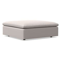 a white ottoman sitting on top of a white floor