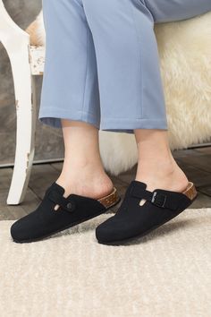 Exude casual-cool style in comfort in these slip-on-and-go clogs, crafted from a soft suede in a versatile neutral hue for effortless pairing. A durable TPU sole ensures tread-safe steps. Suede upper Man-made leather lining Man-made insole TPU sole Comfortable Flat Heel Mules With Buckle Closure, Comfortable Flat Clogs With Buckle Closure, Comfortable Clogs With Buckle Closure And Flat Heel, Casual Flat Slippers With Buckle Closure, Casual Slip-on Slippers With Buckle Closure, Casual Closed Toe Clogs With Cork-bed Midsoles, Casual Clogs With Cork-bed Midsoles, Casual Black Mules With Cork-bed Midsoles, Casual Flat Clogs With Leather Footbed