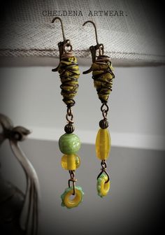 Art Jewelry 'Sun Pod Dangle Earrings'  Pure aged brass wire, multicolored Lampwork beads, recycled sari silk pods. Antique Brass Lever ear wires. Shoulder duster length: approximate 3" long Sunny and beautiful! Cheldena ArtWear™ --'"".--'""-- Bohemian Glass Beaded Drop Earrings, Bohemian Glass Beaded Earrings With Ear Wire, Bohemian Beaded Earrings With Glass Ear Wire, Adjustable Wire Wrapped Whimsical Earrings, Whimsical Adjustable Wire Wrapped Earrings, Handmade Glass Bohemian Earrings, Green Earrings For Jewelry Making, Whimsical Yellow Jewelry With Ear Wire, Yellow Whimsical Dangle Earrings