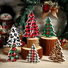 wooden christmas trees are decorated with plaid and snowflakes for the holiday season, along with other decorations