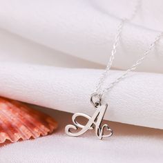 The Handmade Letter Necklace gold, which we offer in 925 Sterling Silver or 14 Karat Gold, is the perfect gift for Mothers Day. The 14K solid version of the letter necklace gift also comes with a 14K solid gold chain. This handmade tiny letter necklace is Silver or gold and perfect Made with quality.  PRODUCT HIGHLIGHTS  Made of high quality 925 Sterling Silver or 14K Solid Gold Necklaces for Women. You can personalize this silver necklace with your or your loved ones' names. For further customi Dainty Silver Initial Necklace For Valentine's Day, Mother's Day Sterling Silver Initial Pendant Charm Necklace, Mother's Day Sterling Silver Charm Necklaces, Silver Heart Pendant Initial Necklace In Sterling Silver, Silver Sterling Silver Heart Pendant Initial Necklace, Sterling Silver Charm Necklaces For Birthday And Mother's Day, Sterling Silver Charm Necklaces For Mother's Day And Birthday, Sterling Silver Hallmarked Initial Necklace For Anniversary, Sterling Silver Charm Necklace For Birthday And Mother's Day