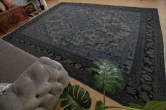 a living room with a large rug on the floor