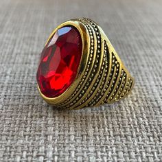 Gold Tone Rings Red Crystal Fashion Ring Men Ring Size 7.5 Unbranded Color: Gold, Red Size: 7.5 Brand New. Never Used. Fashion Jewelry Classic Adjustable Red Ring, Adjustable Red Oval Ring, Adjustable Oval Red Ring, Vintage Adjustable Red Ruby Ring, Adjustable Vintage Ruby Ring, Adjustable Red Crystal Promise Ring, Red Metal Ring Jewelry For Anniversary, Adjustable Red Oval Ruby Ring, Adjustable Oval Red Ruby Ring