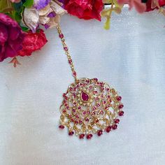 Featuring a large edwardian era inspired jadau maang teeka in 22k gold plateds sterling silver,set with precious freshwater pearls and synthetic stones that resemble rubies. The beads in hangings are real rubies and pearls. The teeka weighs 16gms and the chain length is 8.5cms with a hook at the top All our Gold Plated Jewellery is made using 925 Silver as the base metal. The beads in hanging and strings (like in our 22k gold jewelry) are always precious freshwater pearls and high quality ruby, Red Temple Jewelry Tikka With Cutdana, Pink Tilla Temple Jewelry Tikka, Jadau Tikka, Red Tilla Tikka Temple Jewelry, 22k Gold Jewelry Necklaces, Ceremonial Ruby Meenakari Necklace, 22k Gold Jewelry, Pearl Necklace Set, Gold Jewelry Necklace