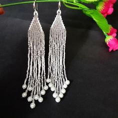 Silvery White Very Long Fringe Earrings. Sparkling, Gentle, Seed Beads Earrings. Indian Jewelry. Boho Style/ Waterfall earrings.These earrings are perfect for a wedding dress.Gradient bead earrings.Boho style Seed Beads earrings. Long Earrings. Beautiful,Sparkling, Elegant Earrings .A beautiful Christmas gift for women and girlfriend. These are long but not heavy earrings. Length of earrings 14 cm (5.50 inches). Width of earrings 0.78 inches. Materials;Czech seed beads.Czech Crystals.Japanese se Silver Beaded Earrings With Dangling Beads For Party, Silver Beaded Dangling Earrings For Party, Silver Long Drop Beaded Earrings For Party, Silver Earrings With Silver Beads For Party, Elegant Silver Chandelier Earrings For Festival, Elegant Silver Beaded Earrings For Party, Dangle Chandelier Earrings With Silver Beads, Silver Chandelier Earrings With Dangling Beads For Party, Handmade Silver Beaded Earrings For Party