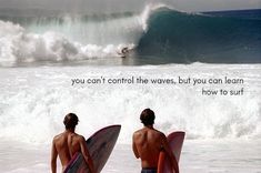 two surfers are standing in the water with their surfboards