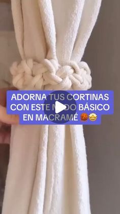 someone is holding up a white towel with the words adorna tus cortinas