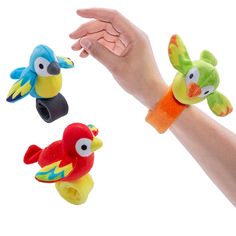 three finger puppets in the shape of birds being held by someone's hand with both hands