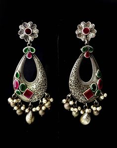 Stunning German silver Indian Chandbali earrings, embellished with sparkly cut CZ stones. Eye catching asymmetric design with a scrolling floral pattern on one half of the earring, and the CZ stones on the other half! Beautiful dangly pearls and silver color stamped balls move when you move, in a very alluring way! Pretty ear stud in shape of flower. Grey finish, polished to a lovely soft lustre. Lots of intricate detail! Excellent quality and craftsmanship! Length 3 3/4 in Width 2 in Weight 14 Silver Pearl Earrings With Stone Work For Gift, Silver Meenakari Chandelier Earrings For Festivals, Silver Pearl Earrings With Stone Work For Celebration, Silver Fusion Bridal Earrings With Intricate Design, Silver Kundan Pearl Earrings With Stone Work, Silver Meenakari Chandelier Earrings For Diwali, Silver Traditional Pearl Earrings With Stone Work, Traditional Silver Pearl Earrings With Stone Work, Festive Silver Meenakari Chandelier Earrings