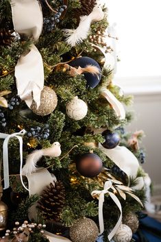 a christmas tree decorated with ornaments and ribbons