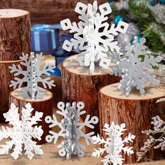 several snowflakes sitting on top of wooden logs