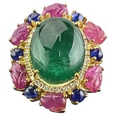 One of a kind art-deco inspired multi-gemstone tutti-frutti cocktail ring. A stunning 12.80 Zambian Emerald cabochon center stone (ideal vivid green color, transparent, great luster) surrounded with Diamonds, Burmese Ruby carvings, and Sapphires - all set in solid 18K Yellow Gold. The ring is currently sized at US 7, can be resized. We provide free shipping, and accept returns. Luxury Unique Round Gemstones, Gem Rings Stones 1stdibs, Elegant Multicolor Cabochon Gemstones, Fine Jewelry Cabochon Gemstones For Formal Occasions, Formal Fine Jewelry Cabochon Gemstones, Exquisite Formal Gemstone Cabochons, Luxury Emerald Ring With Oval Cabochon, Luxury Multi-stone Oval Cabochons, Luxury Multi-stone Cabochons For Formal Occasions