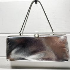 Vintage Silver Metallic Clutch Handbag | Evening Formal Bag Measurements- see pictures! *This item is in pre-owned, vintage condition. All of our items have a past life. We report damage when we notice it but please understand that these items are passed along and that is why we love them. While I've checked it and have listed all details here, there may be an imperfection here or there due to its age. WE DO NOT ACCEPT RETURNS.  *Due to differences in screen settings, colors may slightly differ between photos and physical product. Message me with any questions! Formal Bag, Metallic Clutch, Bag Measurements, Evening Formal, Past Life, Clutch Handbag, Vintage Silver, Evening Bags, Purses And Handbags