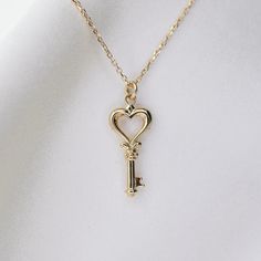 14K gold heart key necklace 14K gold heart key charm is about 18mm x 8.5mm 14K gold 1 mm diamond-cut cable chain All components are 14k gold Gold Heart Necklace With Two Keys, Gold Key Pendant Jewelry, Gold Pendant Jewelry With Keys, Luxury Gold Jewelry With Keys, Elegant Two Keys Necklace As Gift, Elegant Two Keys Necklace Gift, Elegant Two Keys Necklace For Gift, Valentine's Day Heart Pendant Jewelry With Two Keys, Yellow Gold Key Pendant Jewelry