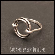 This ring is made with a sterling silver open circle that has a really neat design that twists as it goes around. Sterling silver wire has been added to make up the band of the ring. This ring is super comfortable to wear. Use the options pull down menu to select your ring size. Comes wrapped and ready to gift if needed. To see my other rings, click here: https://www.etsy.com/shop/SusansJewelryDesigns?ref=seller-platform-mcnav&section_id=7658693 Open Circle Ring, Saddle Ring, Circle Jewelry, Circle Ring, Custom Ring, Jewelry Sterling Silver, Initial Jewelry, Ring Sterling Silver, Pearl Ring