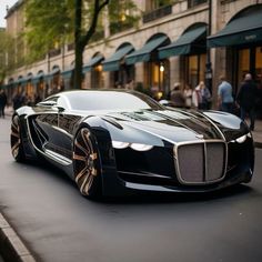 a black and gold bugatti is parked on the street in front of people