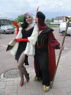 two people dressed in costumes standing next to each other