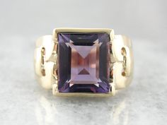 This stunning vintage ring features a luscious Amethyst center, square cut with a lot of glimmer! The simple mounting features beautiful filigree swirl cut-out shoulders that really make this unique and special! Metal: 10K Yellow Gold Gem: Amethyst 4.93 Carats Gem Measurements: 9.9 x 10.6 mm, Rectangle Ring Size: 7.75 Marks: "10K" Stamped on the inside band Formal Purple Amethyst Ring With Rectangular Shape, Formal Rectangular Amethyst Ring, Formal Rectangular Purple Amethyst Ring, Classic Amethyst Ring With Rectangular Stone For Formal Occasions, Elegant Rectangular Amethyst Ring For Formal Occasions, Emerald-cut Amethyst Ring With Gemstone Accents For Formal, Emerald Cut Amethyst Ring With Gemstone Accents For Formal, Classic Purple Rectangular Rings, Classic Rectangular Amethyst Ring