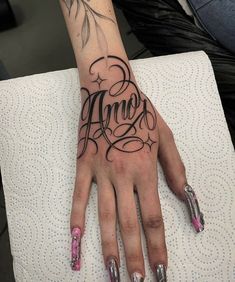 a woman's hand with the word anno tattooed on it