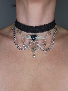 Black elastic with velcro closure creates this choker necklace.  Chains and charms complete the look.  This is a handmade, one of a kind piece of jewelry.  Statement necklace.  Great on its own or can be layered with other necklaces.  Ready to ship. To continue shopping: http://www.rrrobinnn.etsy.com Necklace With Charms, Black Choker Necklace, Jewelry Statement, Black Choker, Unique Charms, Spooky Season, Body Bag, Wearable Art, Charm Necklace