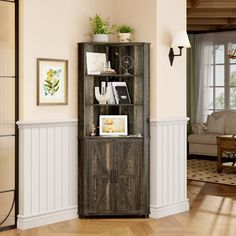 a tall wooden cabinet sitting in the corner of a living room