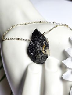 Black Tourmaline is often used as a protective stone, believed to create a shield against negative energies, psychic attacks, and electromagnetic radiation (due to its pyroelectric properties). It helps to balance and align the root chakra (connected to feelings of safety, security, and basic survival instincts). Grounding properties are thought to bring a sense of stability and connection to the Earth.  This necklace features: ~ A coated slab of Raw black tourmaline with Quartz (1.5 x.75 inches) ~ Silver plated satellite chain ~ Faceted Labradorite at the clasp ~ Silver lobster claw clasp ~ Available in 16, 18 or 19 inches.  Thanks for shopping with JewelryByOri! Shop more Tourmaline jewelry from JewelryByOri here: https://www.etsy.com/shop/JewelryByOri?ref=seller-platform-mcnav&search_qu Mystical Black Necklace For Gift, Spiritual Black Necklace With Raw Stone, Black Tourmaline Necklace With Natural Stones, Mystical Black Jewelry For Healing, Black Tourmaline Jewelry As Gift, Black Tourmaline Jewelry Gift, Spiritual Black Jewelry With Large Stone, Black Holistic Necklaces With Natural Stones, Holistic Black Necklace With Natural Stones